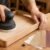 Beginner woodworking tools arranged on a wooden workbench in a bright home workshop