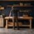 Woodworker reviews a floor plan at the bench inside an organized small garage workshop.